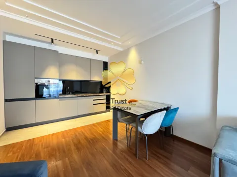Modern kitchen with a dining table and chairs. - image 5