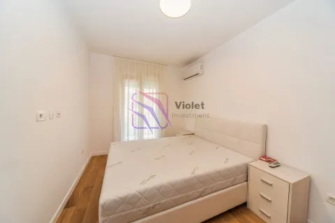 Smaller bedroom with a double bed, nightstand, and air conditioning unit. - image 5