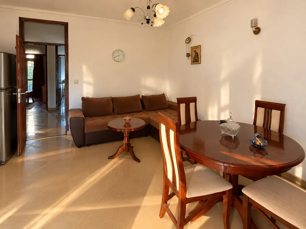 Living room with a sofa and dining table.