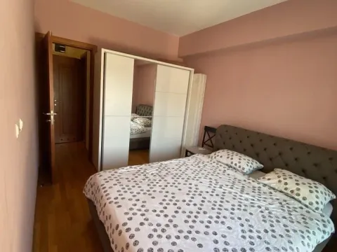 Bright bedroom featuring a double bed and a large wardrobe with mirrored doors. - image 6
