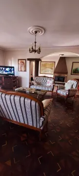 Spacious living room with classic furniture and a fireplace. - image 12