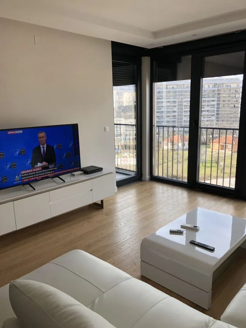 Bright living room with modern furniture and a TV.