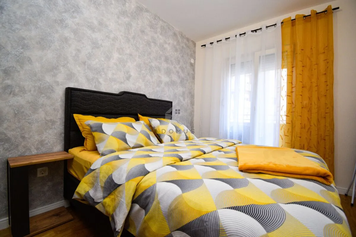 Bedroom with a double bed and yellow details.