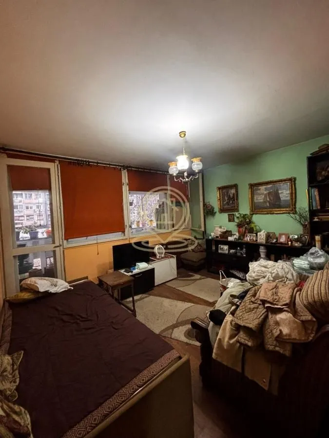 Living room with furniture and windows overlooking the outside.