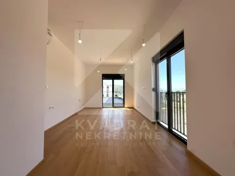 Empty room with wooden flooring and access to a terrace. - image 5