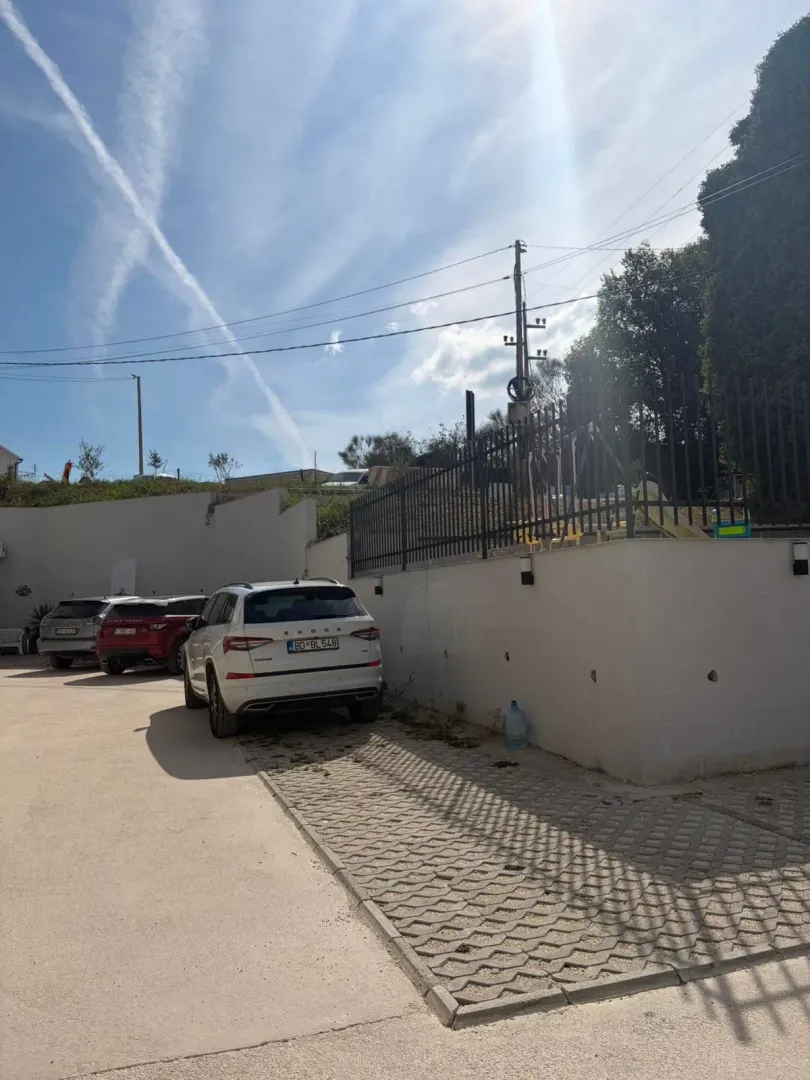 Yard with parking space in front of the building.