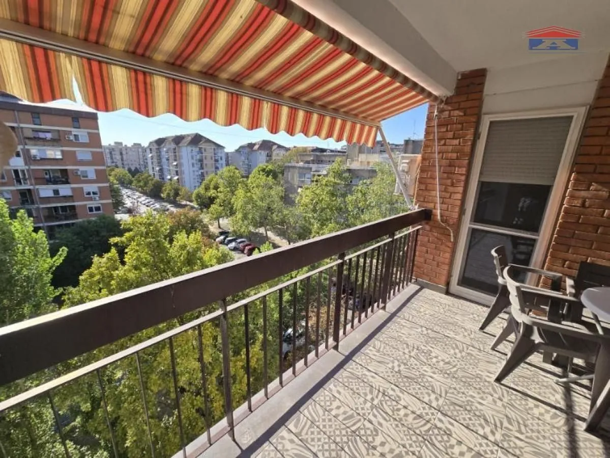 Furnished terrace with city view and awning.