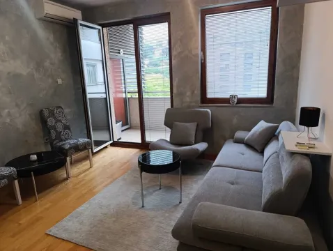 Living room with a sofa, armchair, coffee table, and access to the terrace. - image 3
