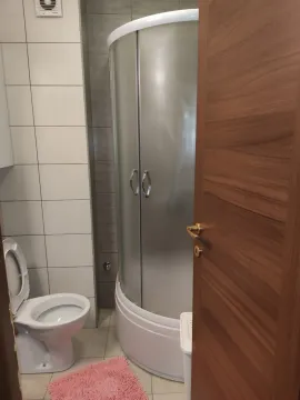 A simple bathroom with a shower cabin and a toilet. - image 24
