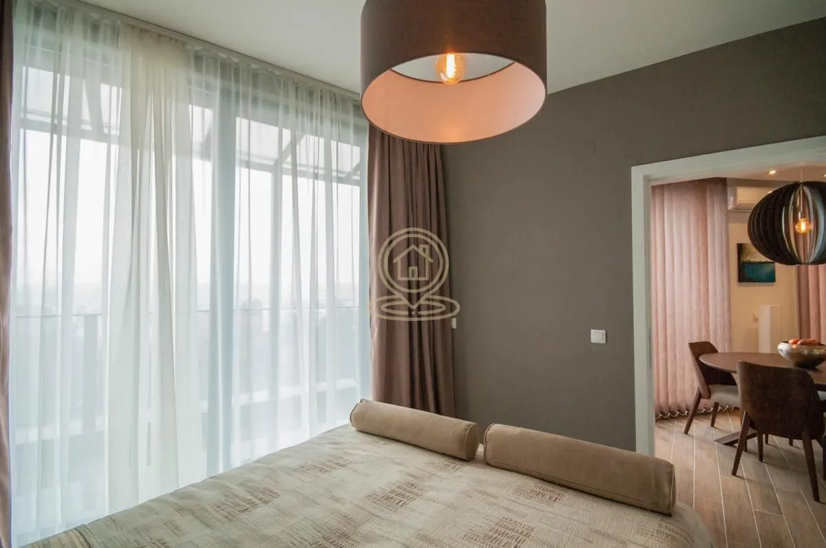 Modern bedroom with a large window and an interior view.