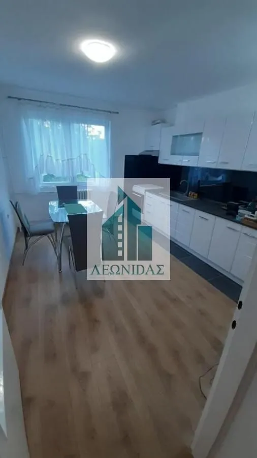 Kitchen with a dining area and white cabinetry.