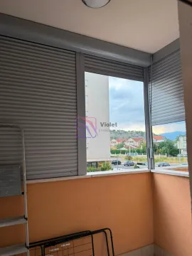 Enclosed balcony space with roller shutters and a view of surrounding buildings and neighborhood. - image 15
