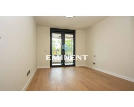 Empty room with hardwood floors and glass balcony doors. - image 5