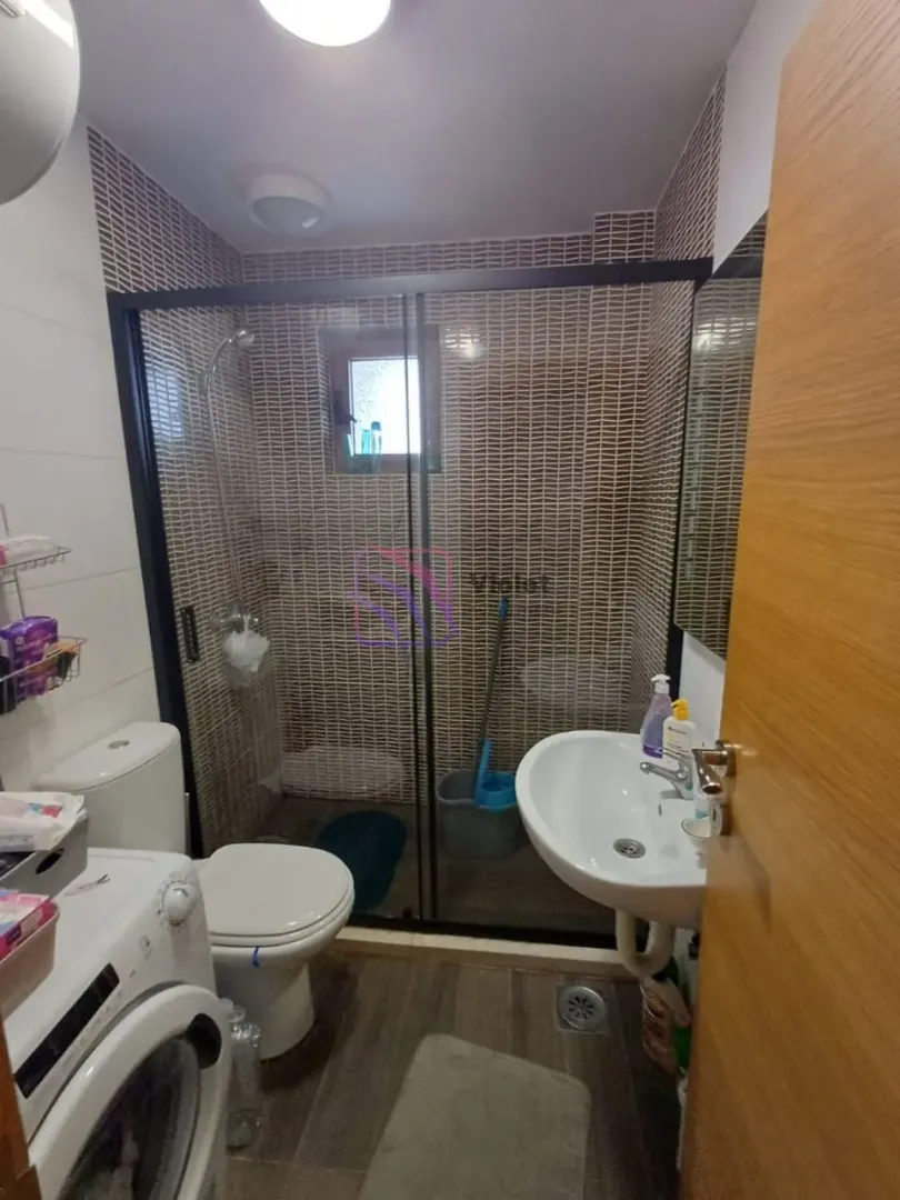 Kupatilo sa tuš kabinom, umivaonikom, toaletom i veš mašinom.