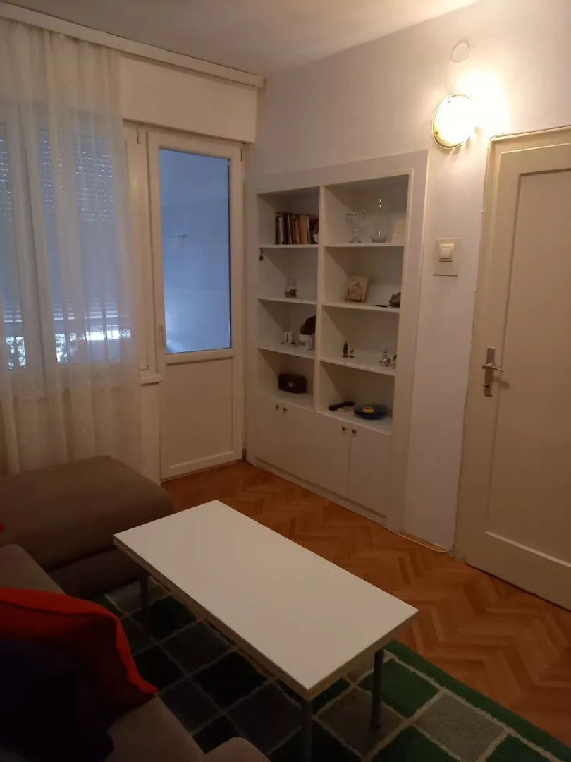 Simple living room with a coffee table and a built-in bookshelf.
