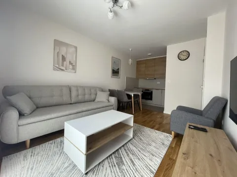Living room with sofa, coffee table and view of the kitchen and dining area. - image 5