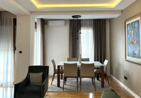 Living room with a dining table and chairs. - image 2