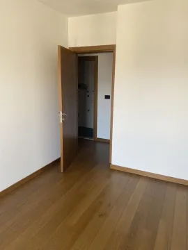 Empty room with wooden flooring and an open door. - image 4