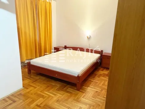 Furnished bedroom with a double bed and yellow curtains. - image 7