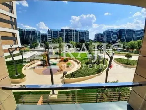 View from the terrace of a landscaped courtyard with a children's playground and surrounding buildings. - image 7