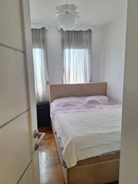 View of the bedroom with a double bed through an open door. - image 4