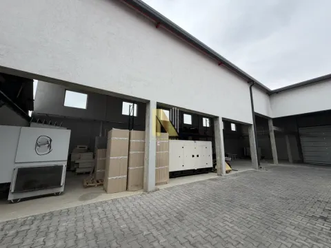 Exterior of a commercial building with storage space and equipment in the yard. - image 2
