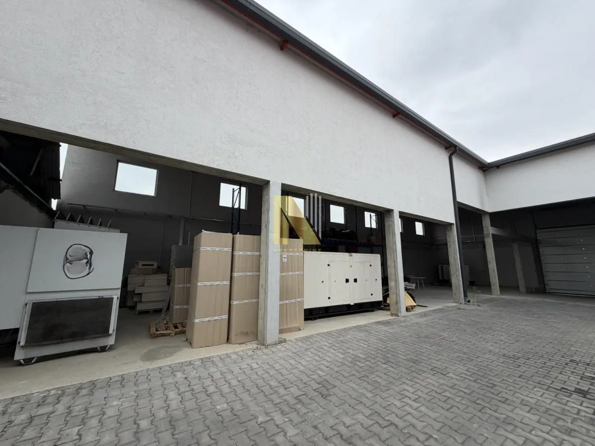 Exterior of a commercial building with storage space and a covered area.