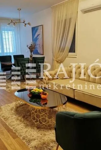 Living room with a sofa, dining table, and glass coffee table.