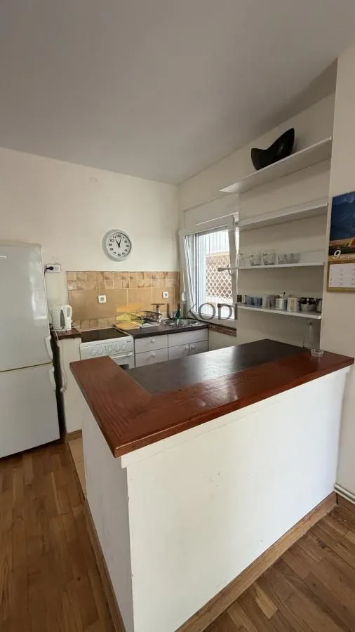 Smaller kitchen with a bar counter and wooden elements.