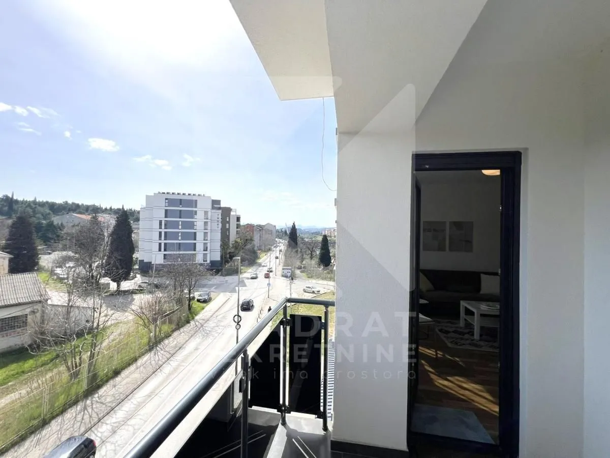 View from the balcony overlooking the street and surrounding buildings.