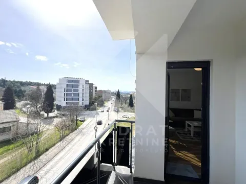 View from the balcony overlooking the street and surrounding buildings. - image 12