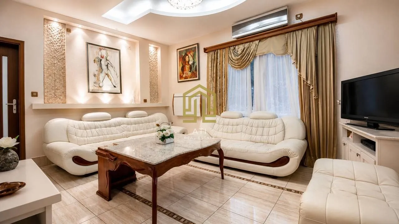 Bright living room with leather sofas and a coffee table.
