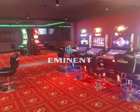 Interior of a commercial space equipped for a casino with slot machines and chairs. - image 3