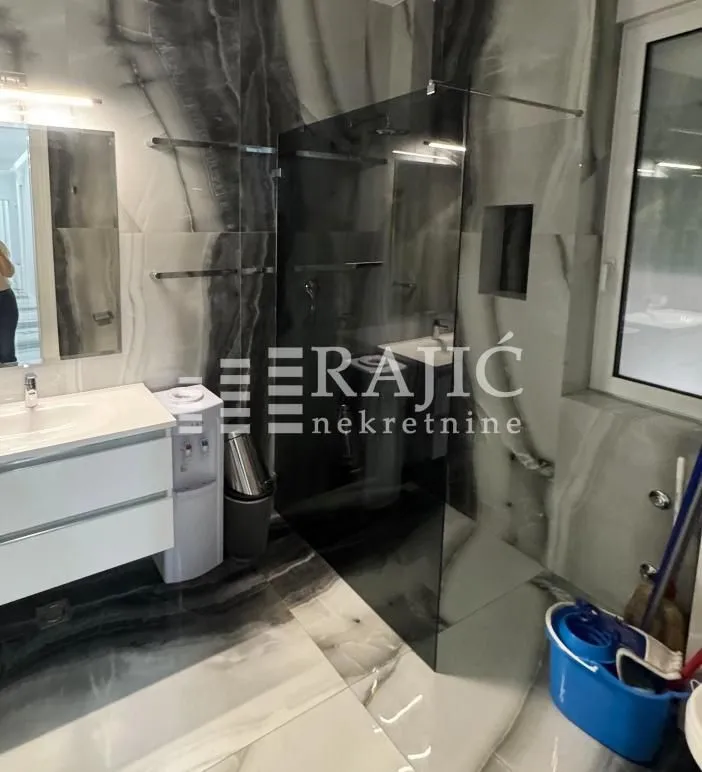 Modern bathroom with a sink and a shower cabin.