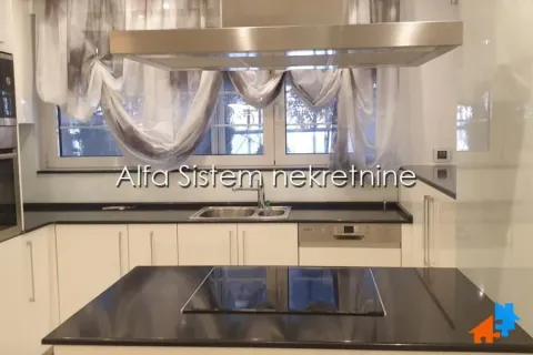 Modern kitchen with an island, sink, and built-in appliances. - image 6
