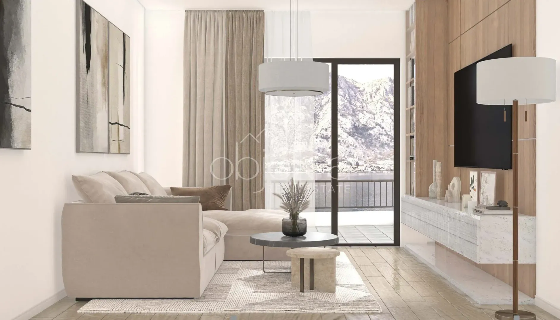 Modern living room with a sofa, TV, and a view of the sea through the balcony doors.