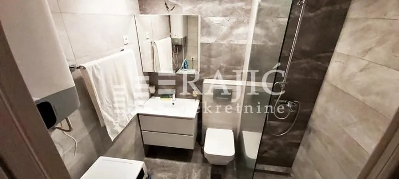 Modernly equipped bathroom with a walk-in shower.