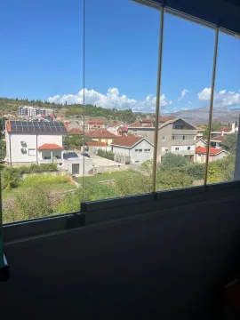 View of the neighborhood and surrounding mountains through a glazed terrace. - image 3