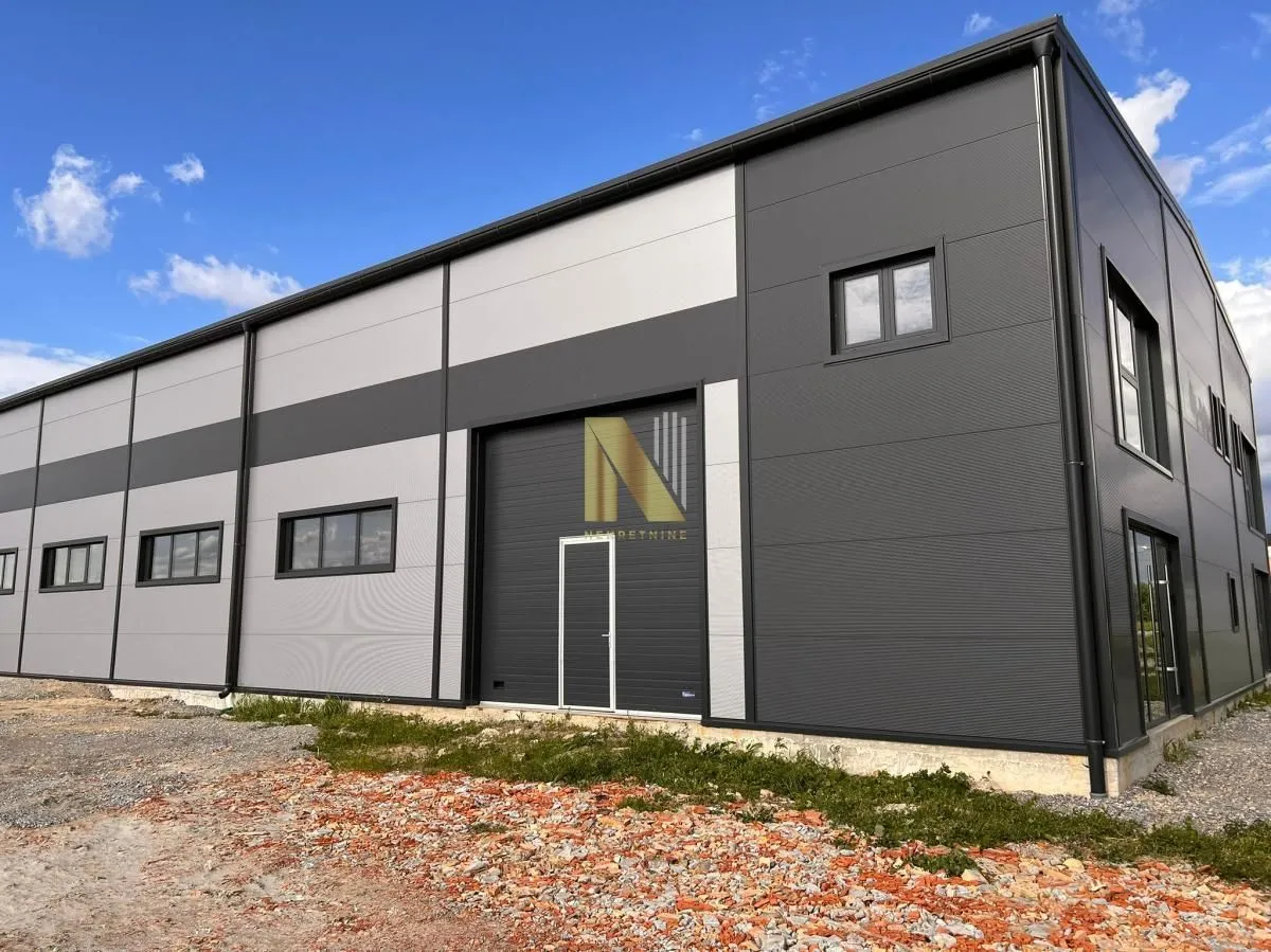 Exterior view of a modern industrial warehouse with metal facade.