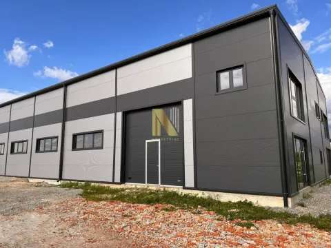 Exterior view of a modern industrial warehouse with metal facade. - image 5