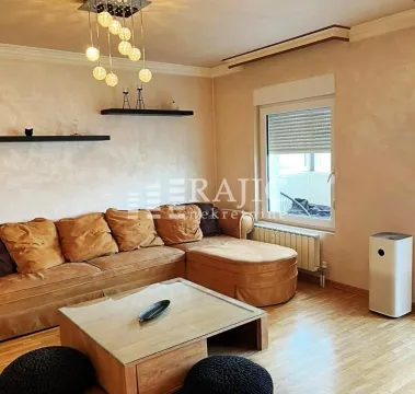 Living room with a corner sofa, coffee table and lighting. - image 6