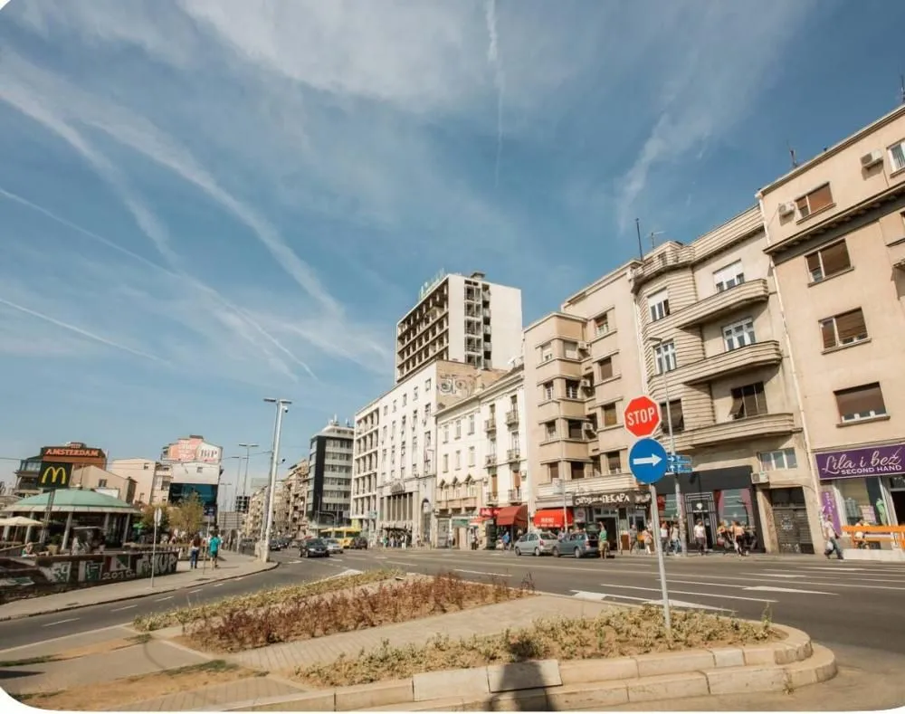 View of the city street with buildings and traffic.