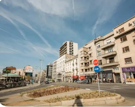 View of the city street with buildings and traffic. - image 18