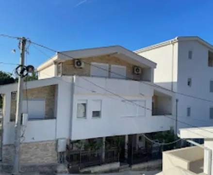 View of the exterior of the house with a white facade and terraces. - image 2