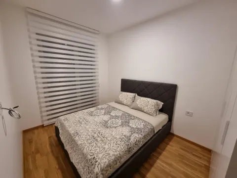 A bedroom with a double bed and a window with blinds. - image 17