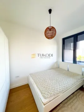 Bright bedroom with a white bed, wardrobe, and pendant light. - image 4