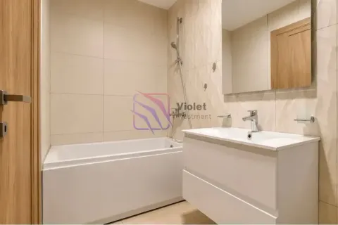 Modernly equipped bathroom with a bathtub and a washbasin. - image 14