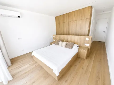 Modern bedroom with a double bed, wooden furniture, and built-in wardrobes. - image 11