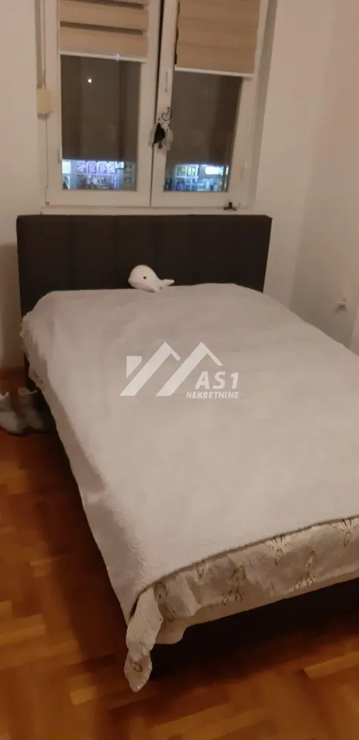 Bedroom with a double bed and a window.