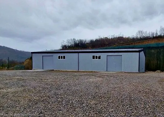 View of the exterior of a prefabricated building with doors and windows.